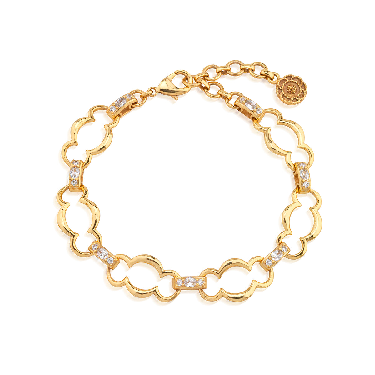 A gold-tone bracelet with a repeating clover or quatrefoil link pattern, accented with small clear stones on several links, shown on a plain white background.