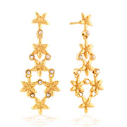 A cascade of golden jasmine blossoms studded with tiny luminous pearls creates this light and airy pair of statement earrings. Ornate, playful and elegant, these gold and white botanical beauties are fabulously versatile—your go-to accessories for day to night, weekday to weekend styling.