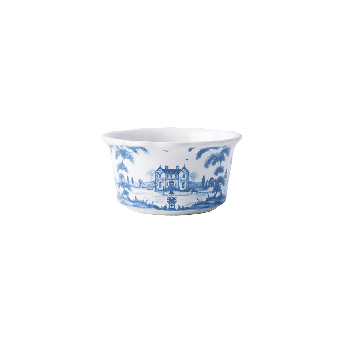 A white ramekin with a blue country estate design painted on it.
