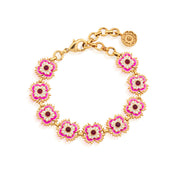 Hello, arm candy! This sweet bracelet brings a feminine flourish to whatever you wear it with (from basic tee to tailored shirt to floaty dress) with its ruffled dianthus blossoms in charming petal pinks and white trimmed in bright gold. This dainty confection of a link bracelet features vibrantly hand-painted enamel flowers intricately set with fuchsia jade gemstone centers for a dose of flower power that’s subtle yet striking.
