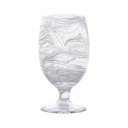 Like swirling water and the decorative pages of Florentine leather-bound books, this marbled goblet adds an eclectic splash to your everyday table with its captivating motif in soft seaglass hues of white, blue, and green for a joyful pop of color. These chic vessels are perfect for your morning juice and add a super stylish layer to place settings - the abstract pattern mixes beautifully with everything.
