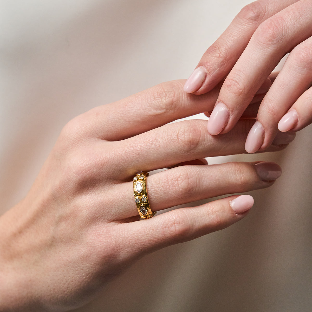 Maharani Hammered Ring - Clear Cubic Zirconia close up on finger