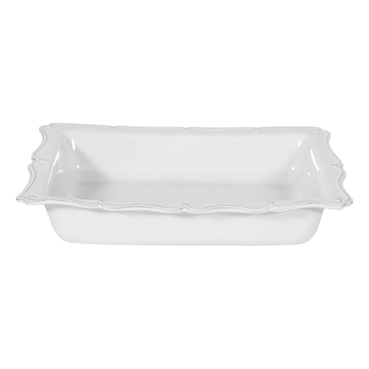 Our oversized 17” rectangular baker features a beautiful, scalloped edge reminiscent of a ruffled apron, perfect for presenting beloved recipes on special occasions or for everyday use. Abundantly sized to feed a crowd and designed to snugly accommodate both our loaf pan (Baker? Need to keep consistent with above) and square baker -- blessedly fitting all three together in your cupboard for space-efficiency.
