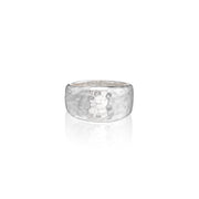 A hammered silver band ring with a textured, dimpled surface, shown on a clean white background with a soft reflection below.