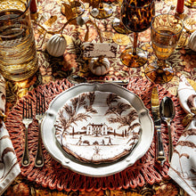 Decorative table setting with a vintage-style plate, cutlery, and autumn-themed decor.