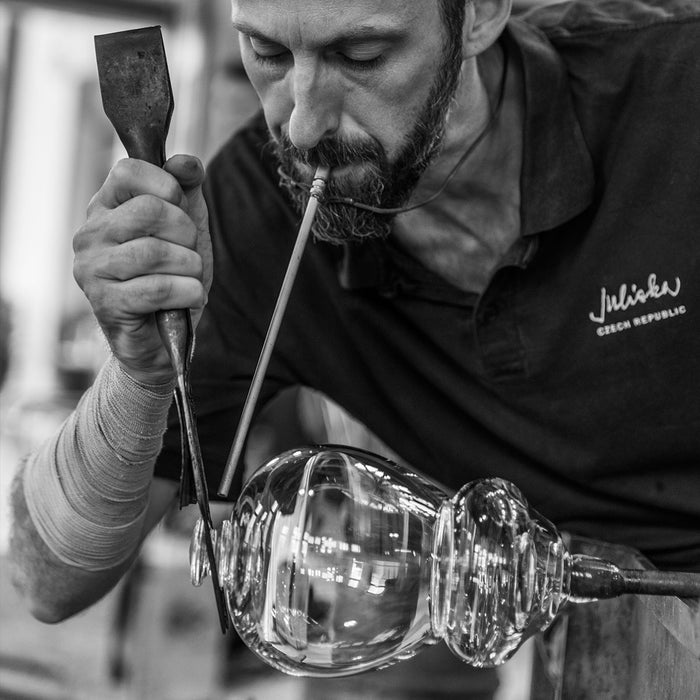 A Juliska artesian glassblower harnesses his skill on a piece of hot glass.