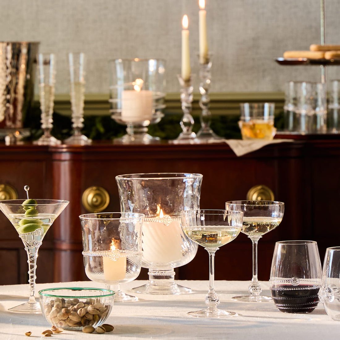 Diverse glasses with drinks and candles on a table