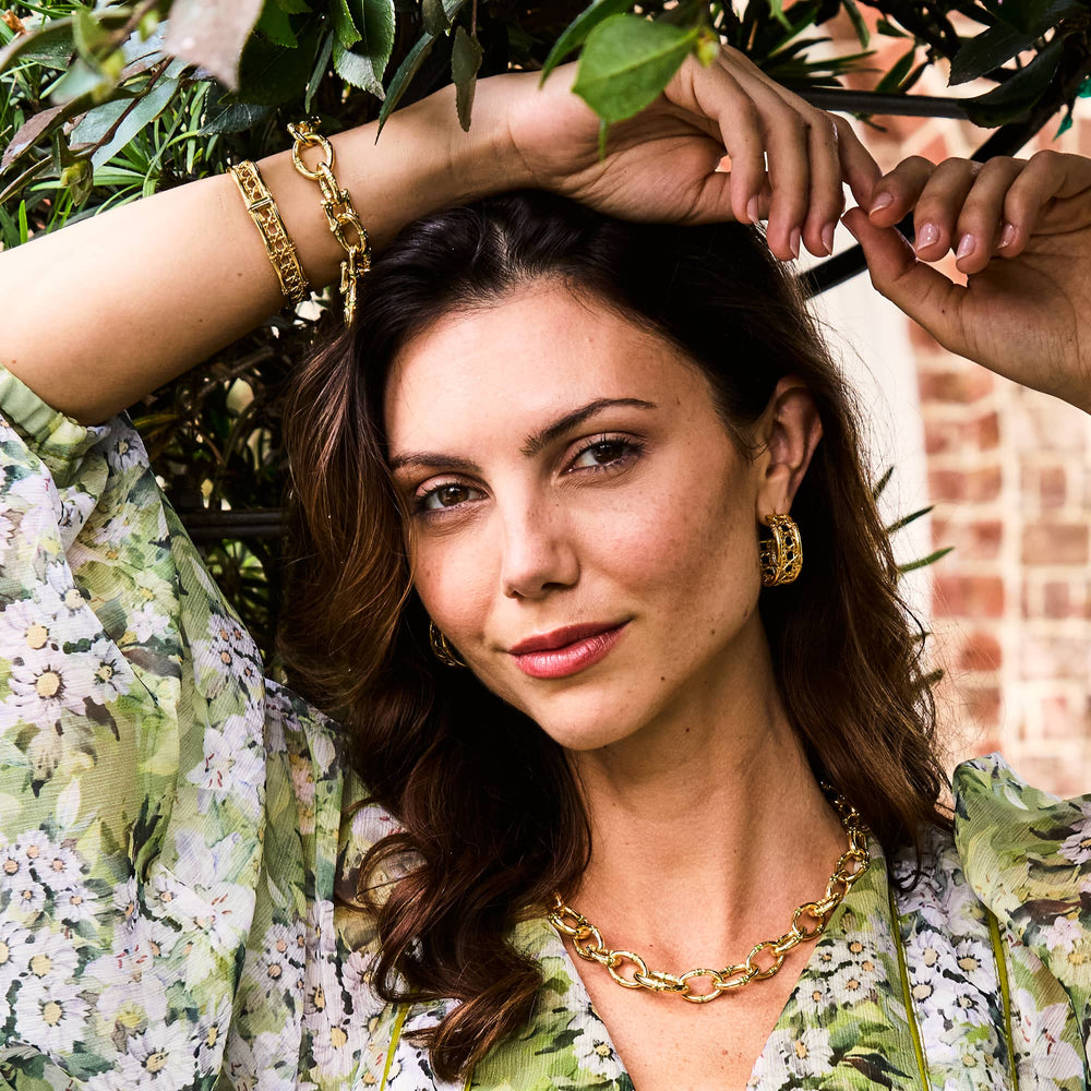 Woman posing under a tree wearing bangkok bamboo jewelry