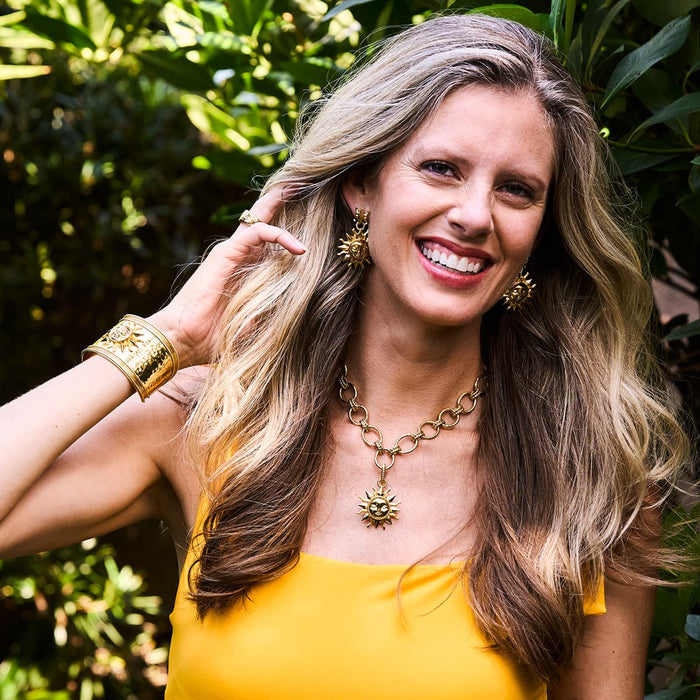 Woman modeling the Soleil Collection jewelry from Capucine De Wulf