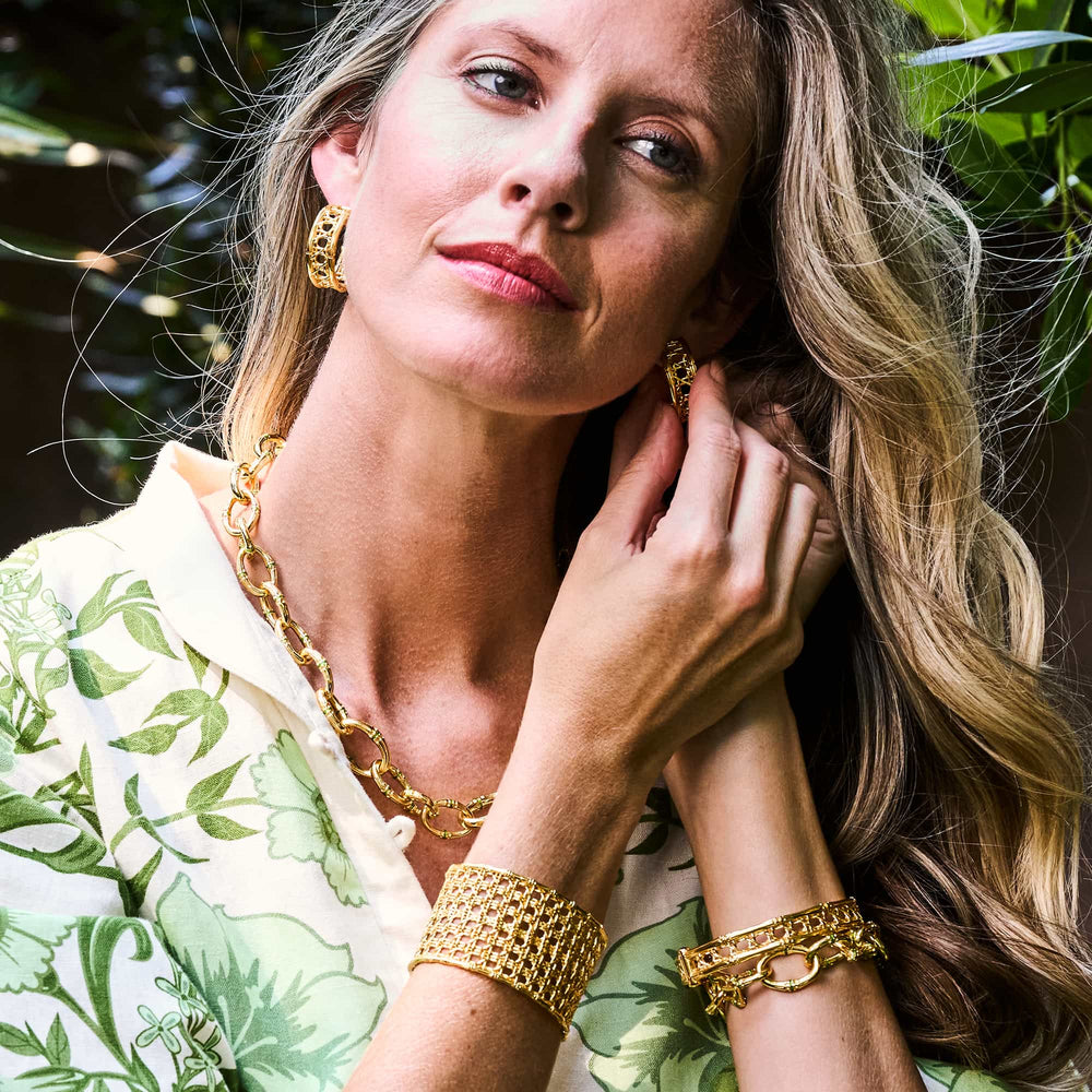 Woman putting in her veranda earrings from capucine de wulf