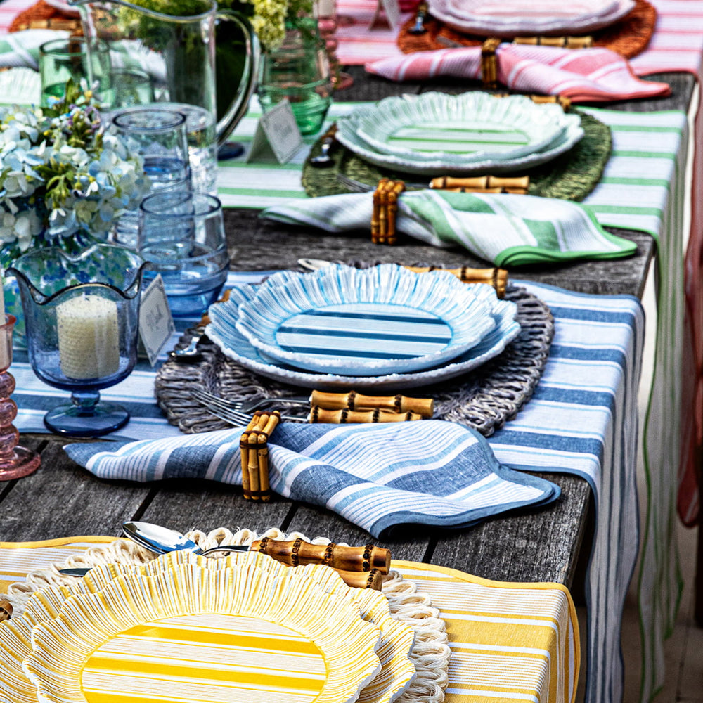 Four place settings featuring different colors of the cabana plates and linens 
