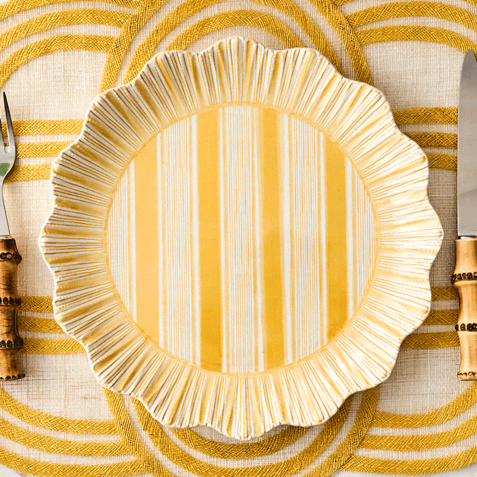 Moveable square gif featuring decorative pink, blue, yellow and green plates on a yellow striped placemat