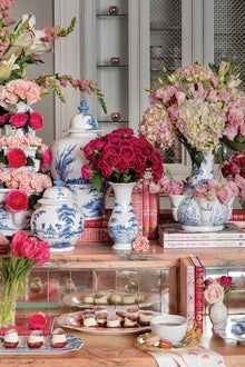 Florals in vases grace a beautiful spread of yummy treats.