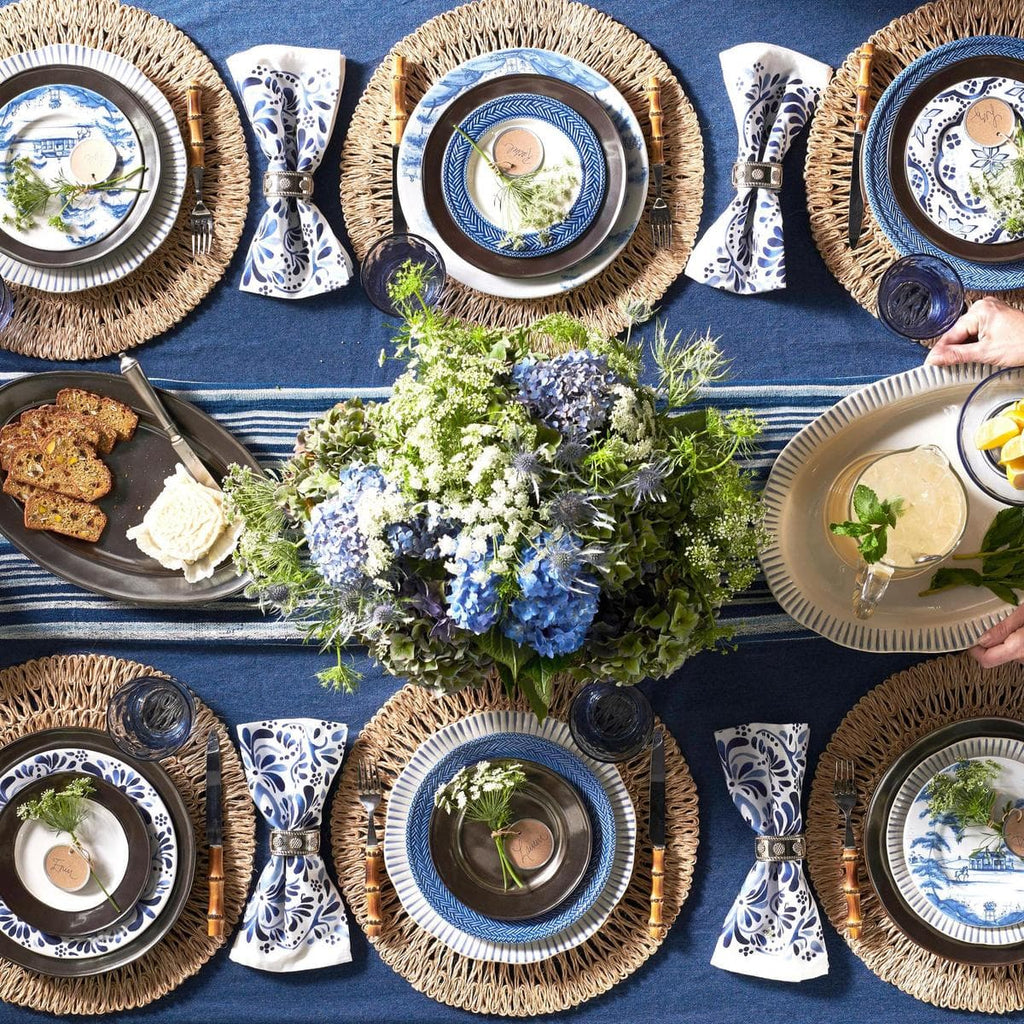 Overhead image of blue, white and tan table settings.
