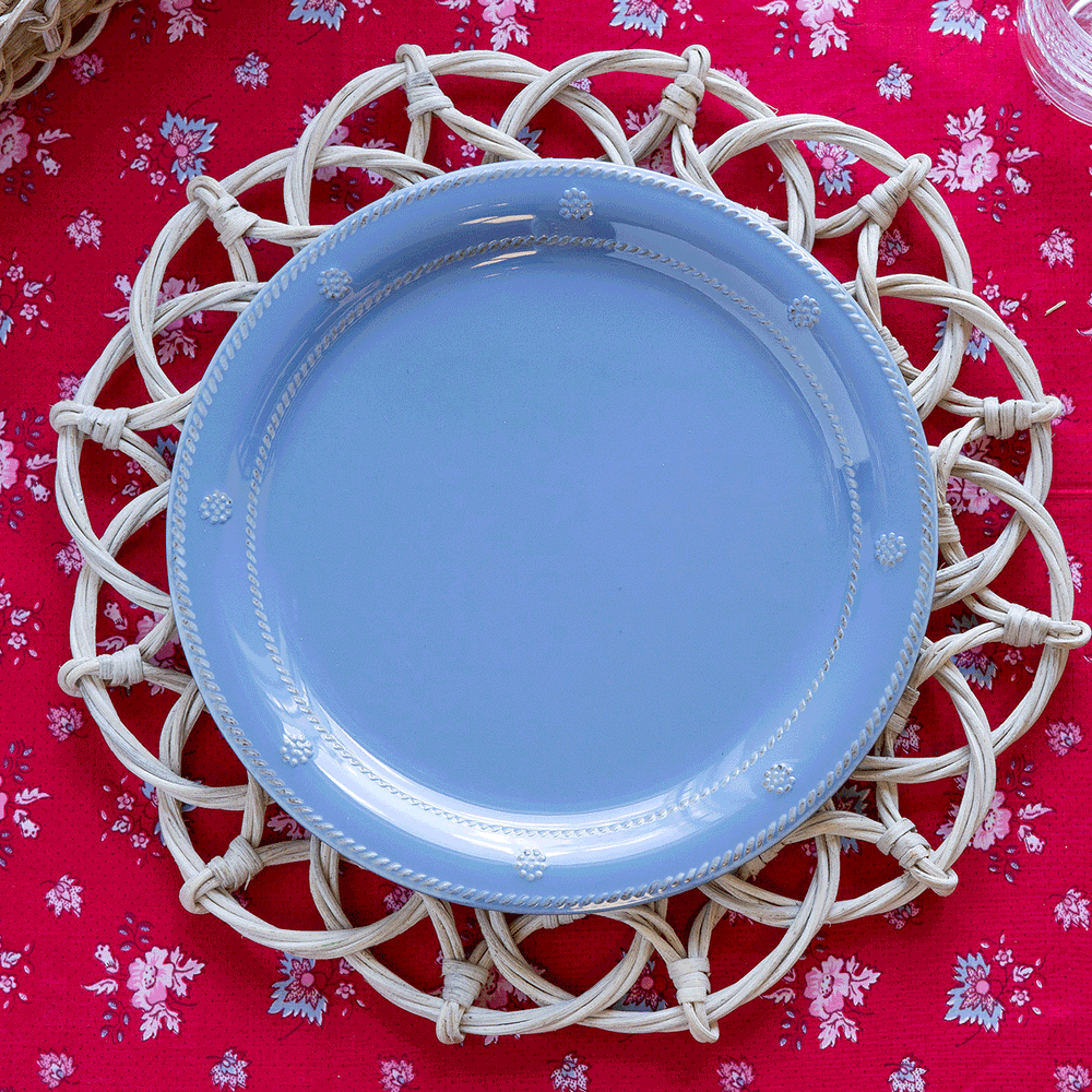 A GIF of blue, white and bamboo plates switching out to create a festive table setting.