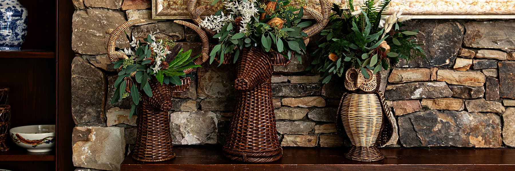 Devon willow stags and owl filled with plants displayed on a mantel