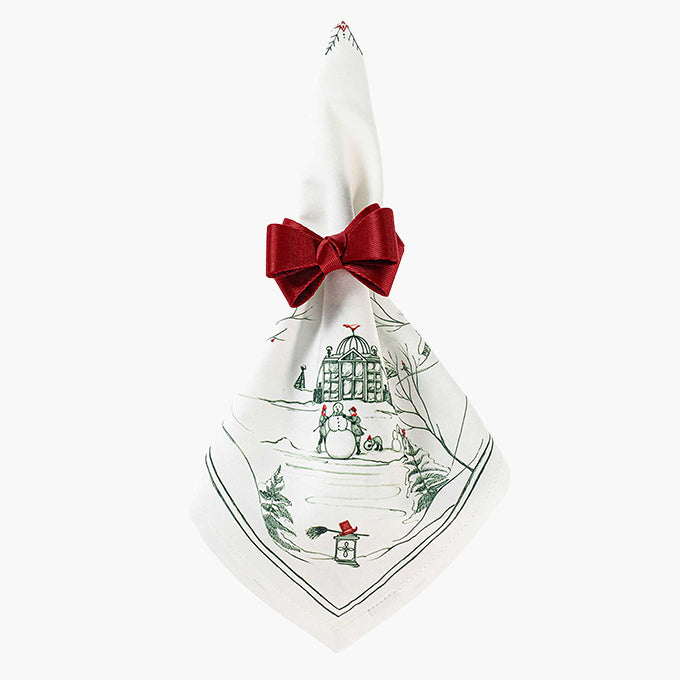 Decorative napkin with Christmas-themed design and a red bow on a white background