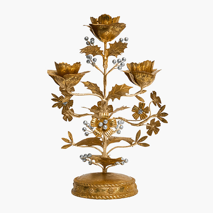 An ornate gold-toned metal floral candlestick holder with five flower heads, leafy branches, and small pearl-like bead accents, displayed against a plain white background.