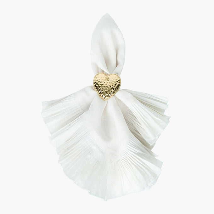White tassel with a gold heart-shaped charm on a white background