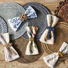 Five folded napkins laid out on top of placemats