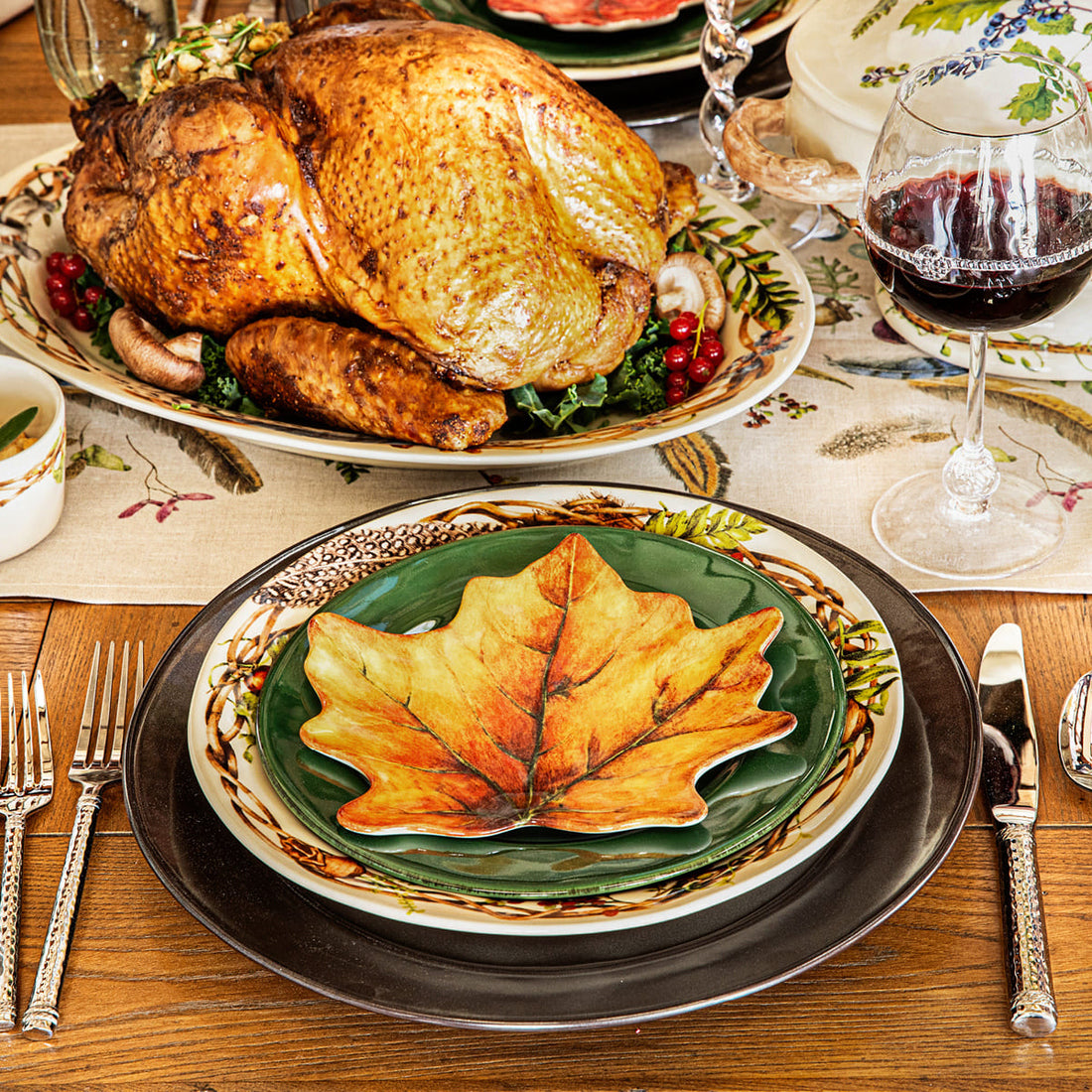 Stacked autumn colored plates create the perfect setting for a Thanksgiving feast.