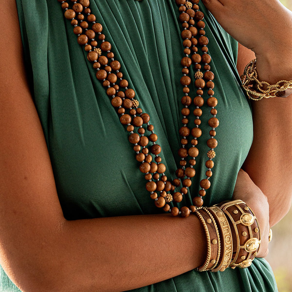 Brown teak beaded necklace pops on green dress.