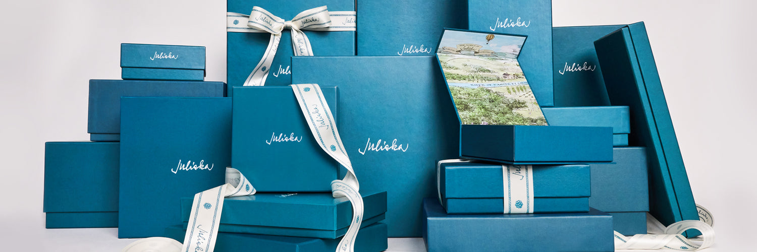 Collection of blue gift boxes with silver ribbons on a white background