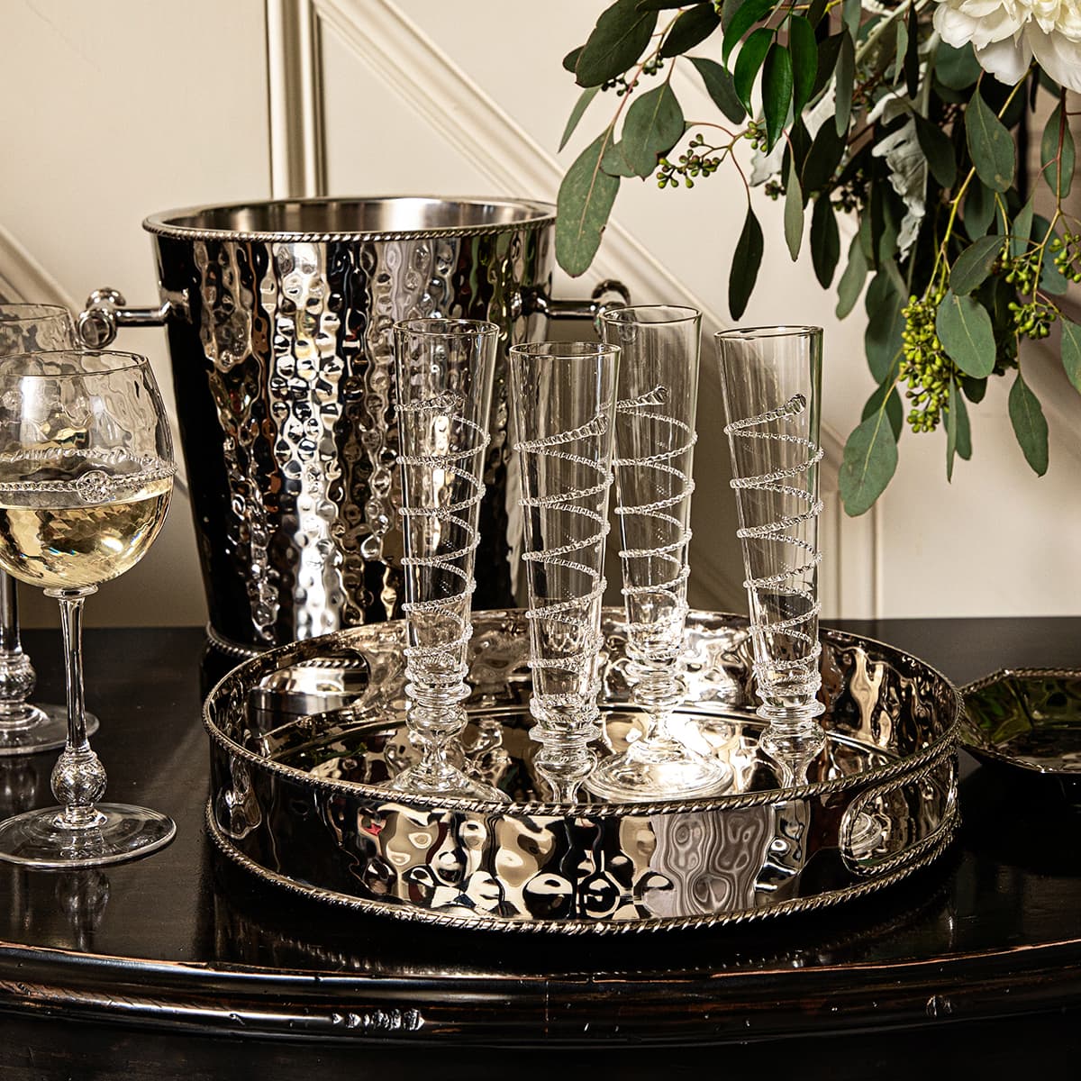 graham metal barware, wine glasses and champagne flutes on a black table