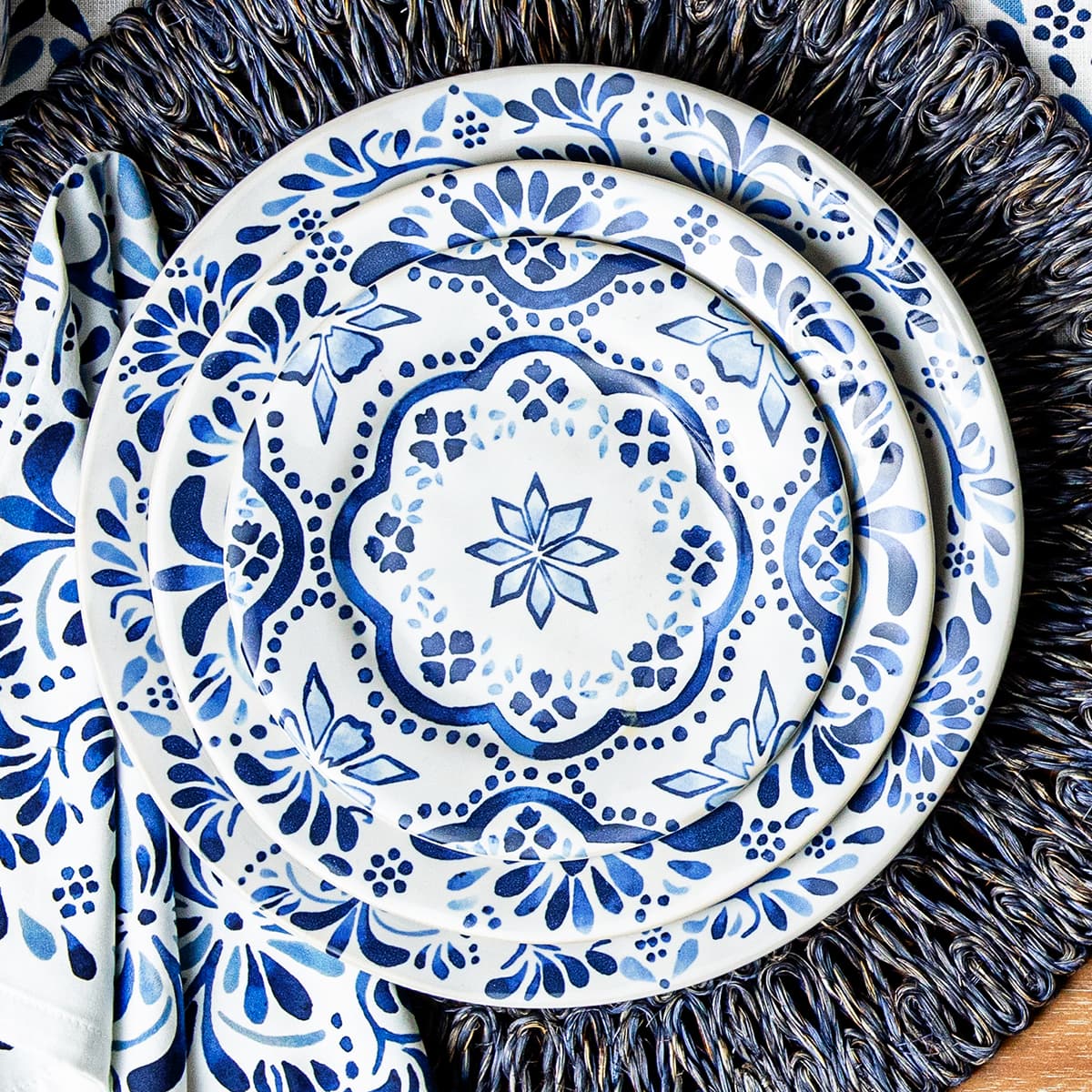3 Iberian plates on top of a dark blue placemat