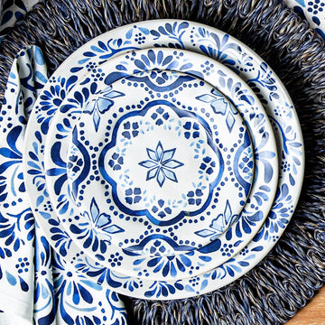 3 Iberian plates on top of a dark blue placemat