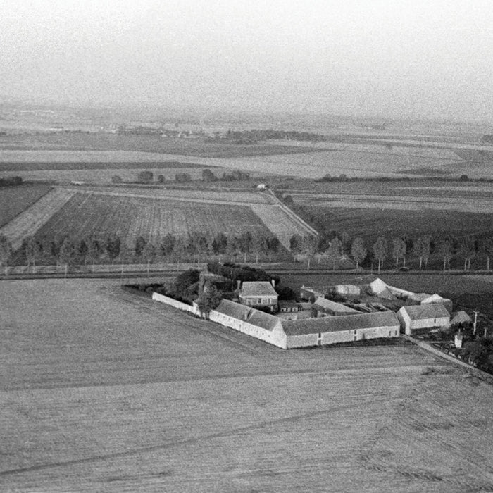 Vintage image in black and white of a large estate amongst the farmlands of France.