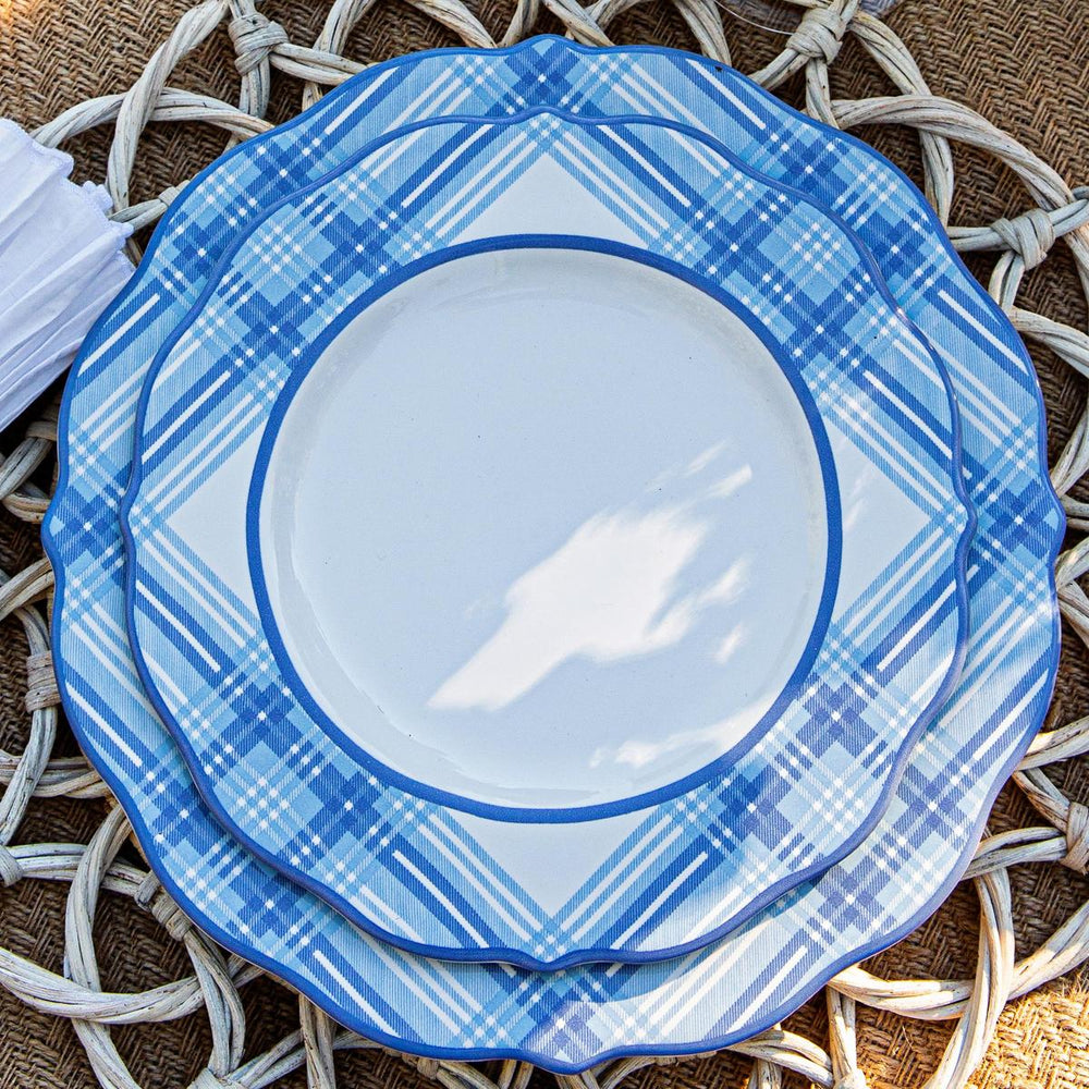A charming place setting of a dinner and salad plate on top of a natural rattan placemat. 