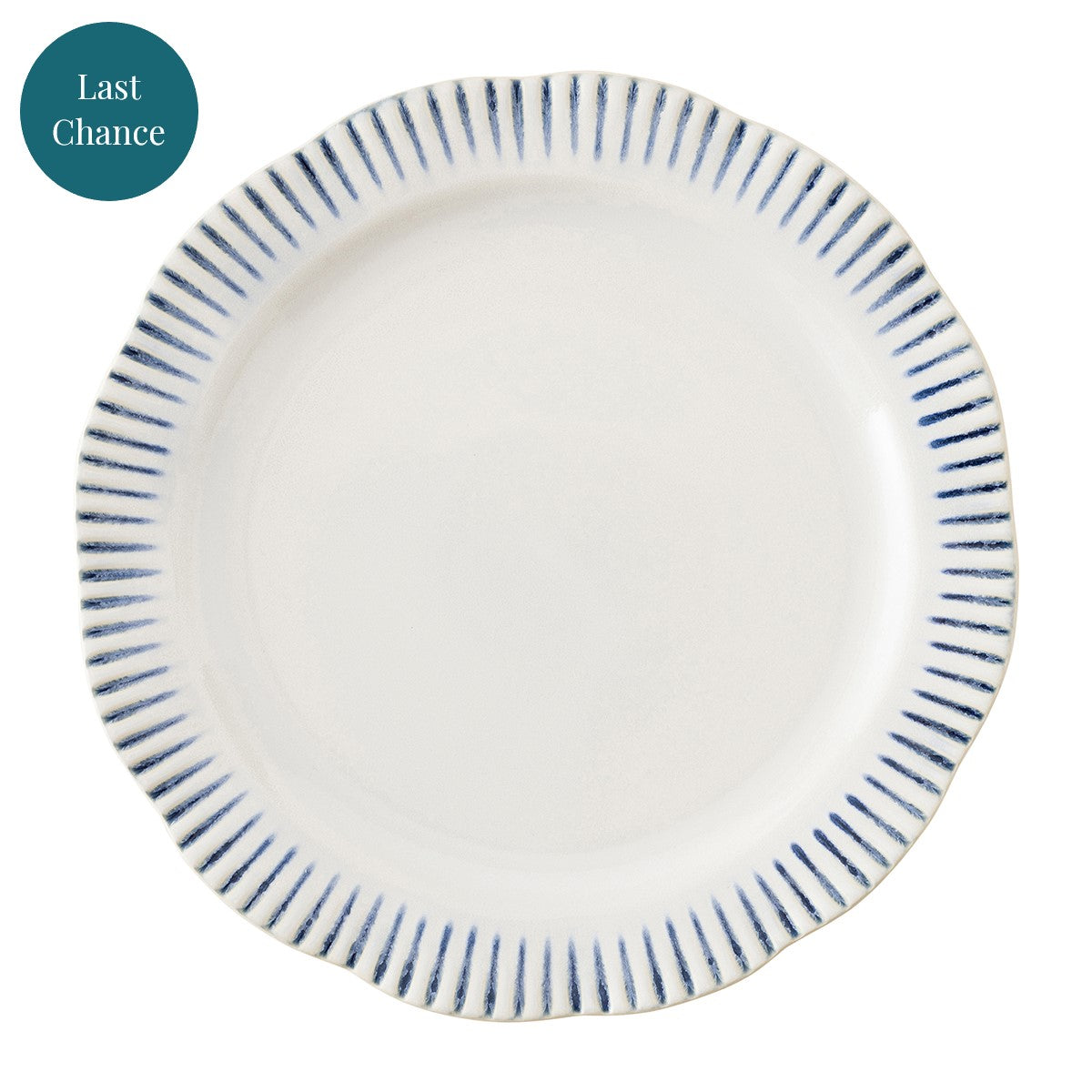 A white dinner plate with blue stripes along the rim.