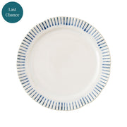 White plate with blue stripes painted along the rim.