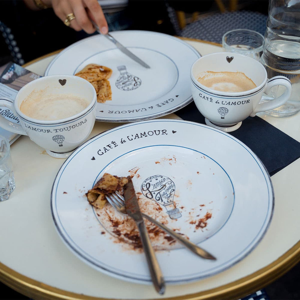 L'Amour Toujours mugs and plates outside a Paris café.