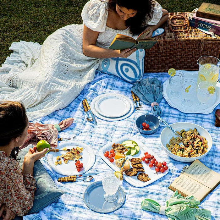 Two women enjoy an outdoor picnic.