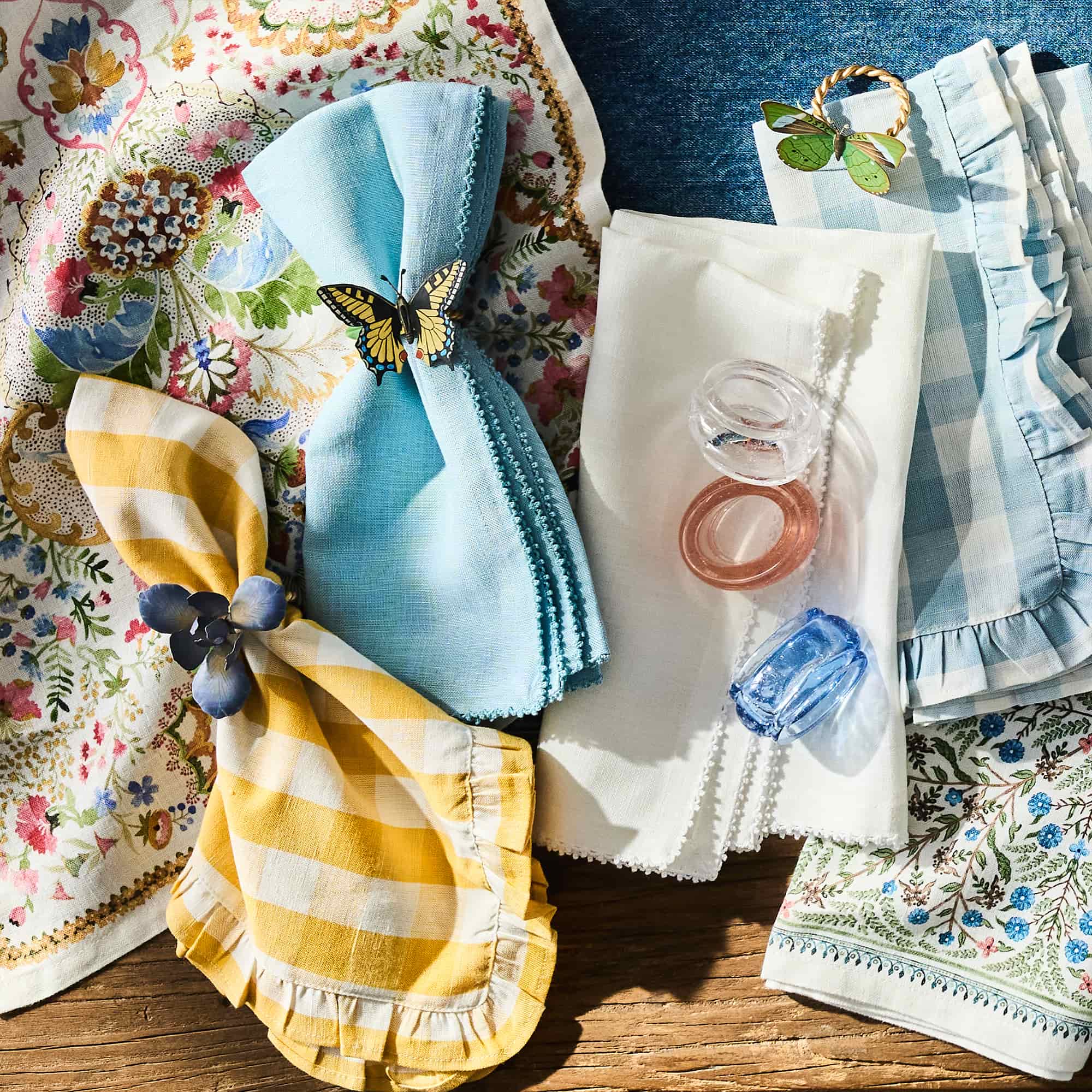 Collection of colorful napkins with decorative elements on a wooden surface