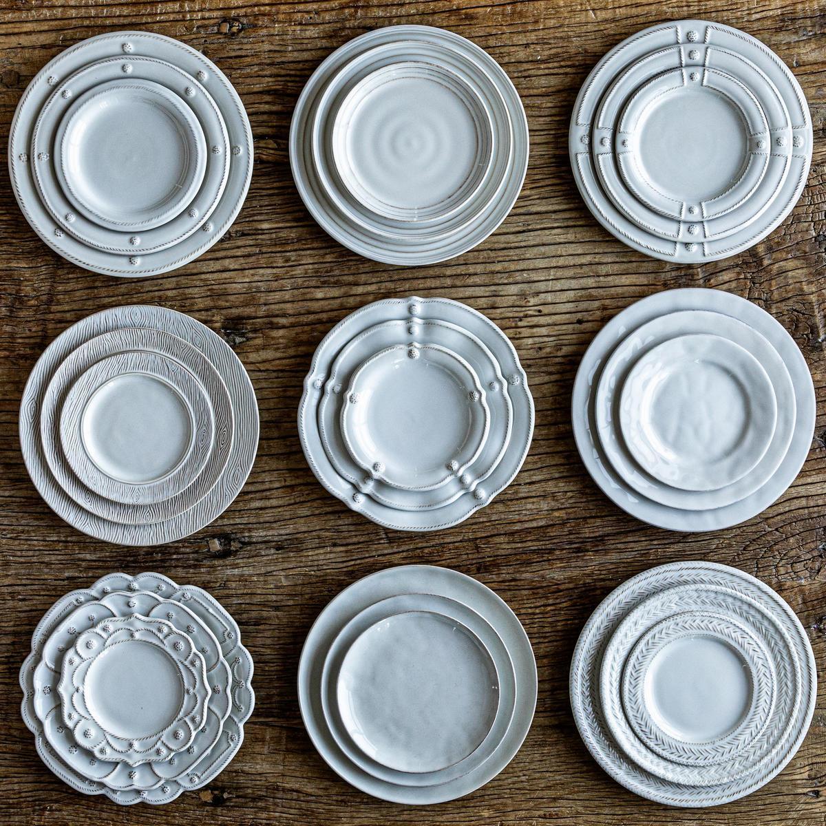 Nine place settings of Juliska whitewash plates stacked 