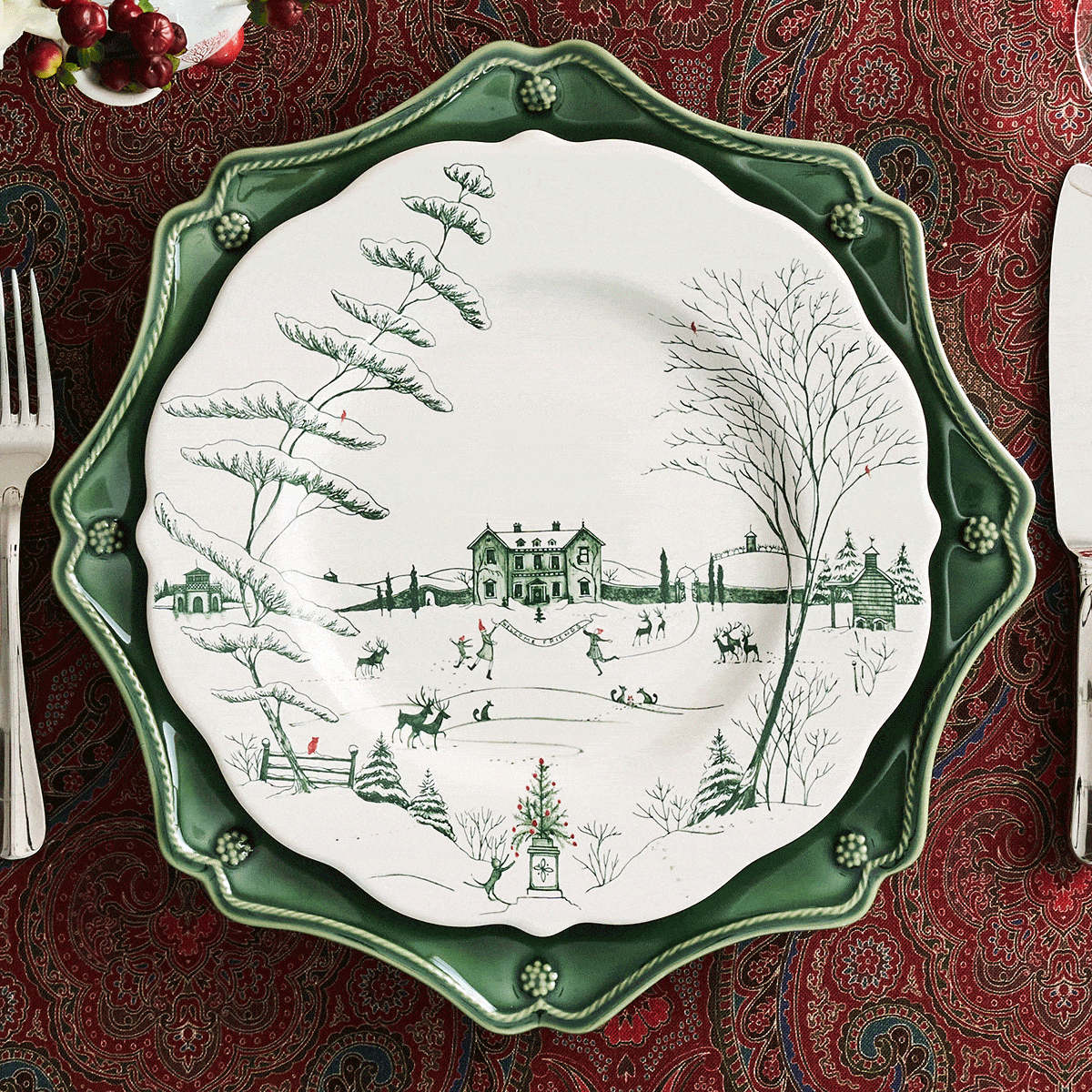 Moveable gif featuring three stacked ceramic plates alternating between green, red and white, and green and white plates set on a red paisley tablecloth.