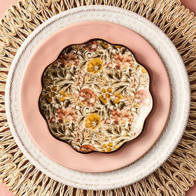 Decorative plate with floral design on a textured surface