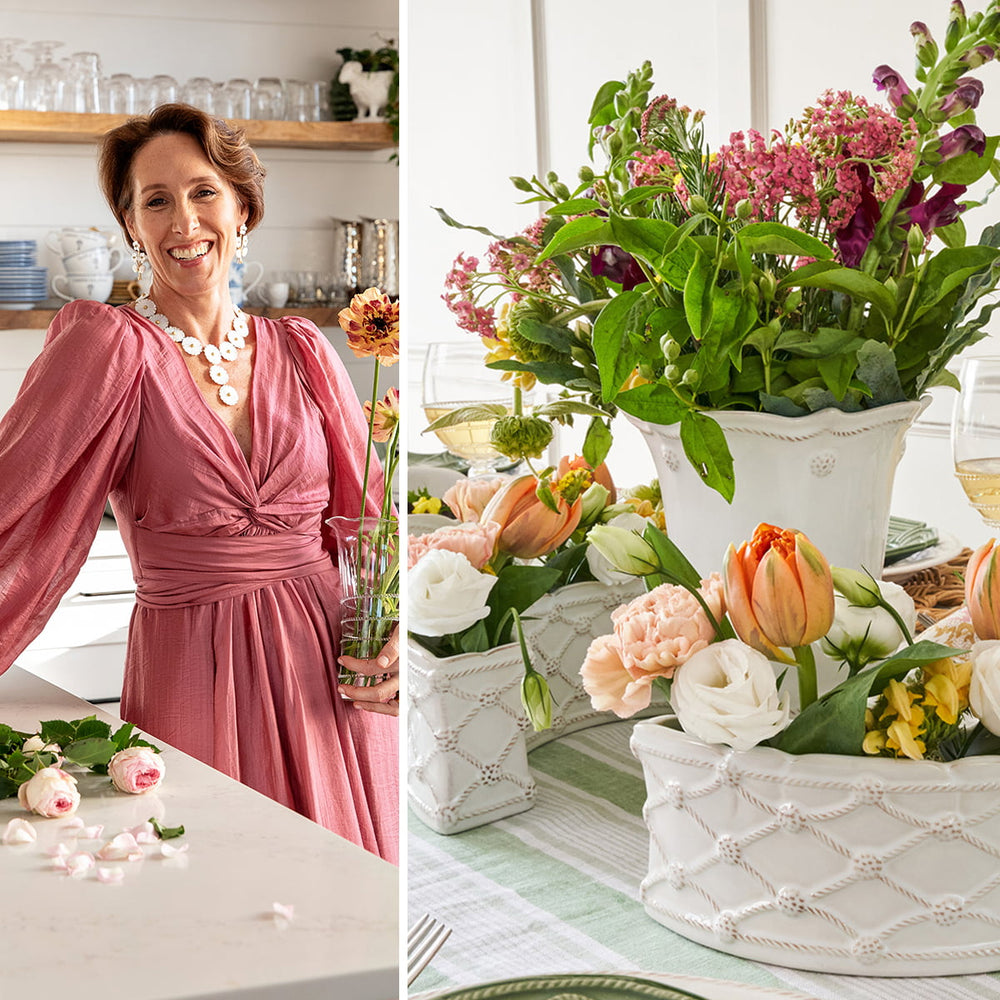 Woman in a pink dress standing next to a table with floral arrangements.