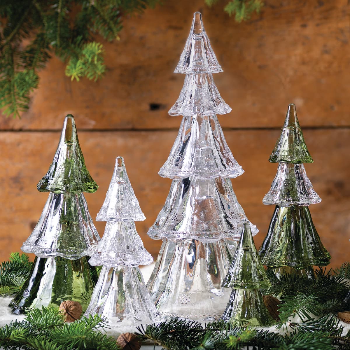 Set of glass Christmas trees with a wooden background