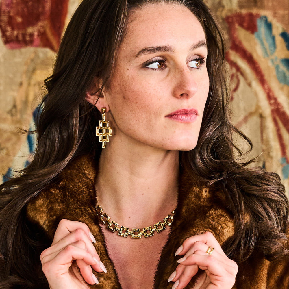 Woman in fur coat modeling gold jewelry from the pathway collection
