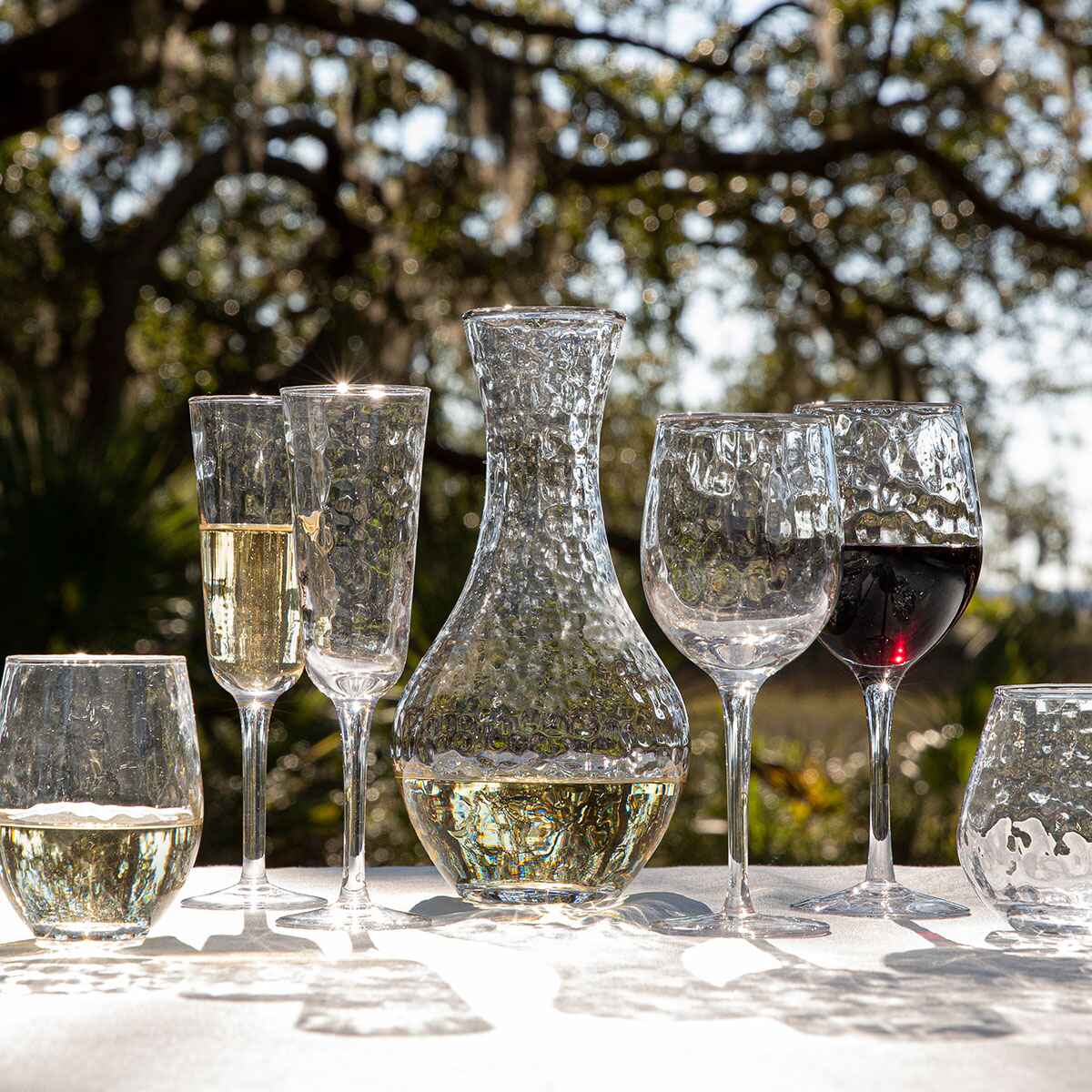 Puro wine glass, coupe and champagne glasses displayed on an outdoor table