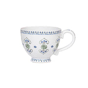 A fresh take on Seville's romantic, folkloric florals, this generous breakfast cup is designed for coffee, tea, and anything else delicious and soothing. We especially adore the sculptural handle, tiny foot and intricate trim adorning the top and bottom.