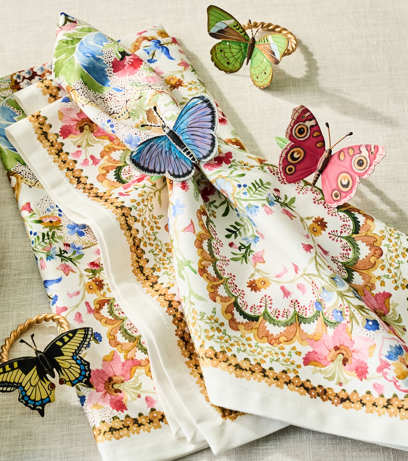 Colorful butterfly-themed fabric designs on a textured surface