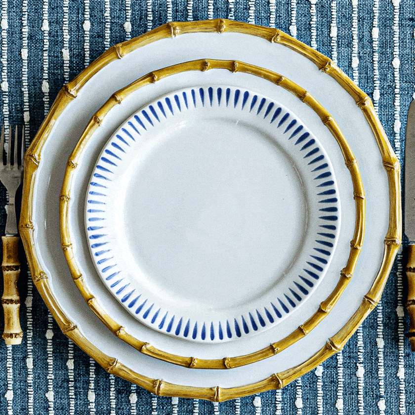Moveable gif featuring bamboo, iberian blue, sitio stripe blue, and le panier dinner and dessert plates on a blue tablecloth