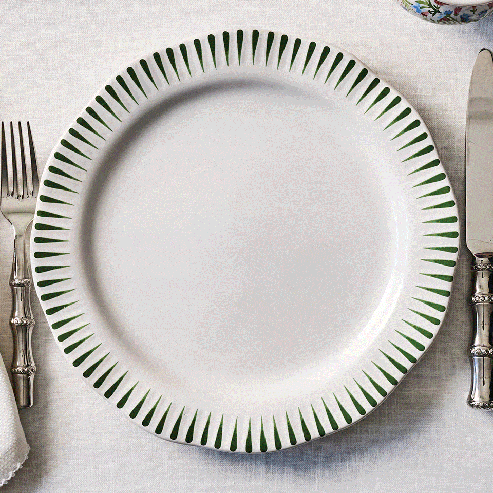 Moveable square gif featuring decorative plate with floral pattern on a table setting with cutlery