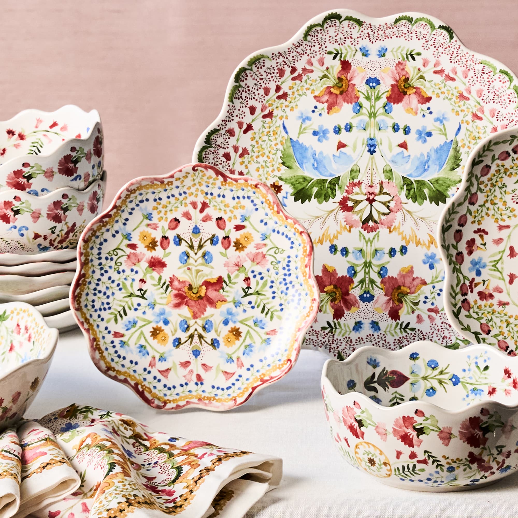 Decorative ceramic plates and bowls with floral patterns on a light background