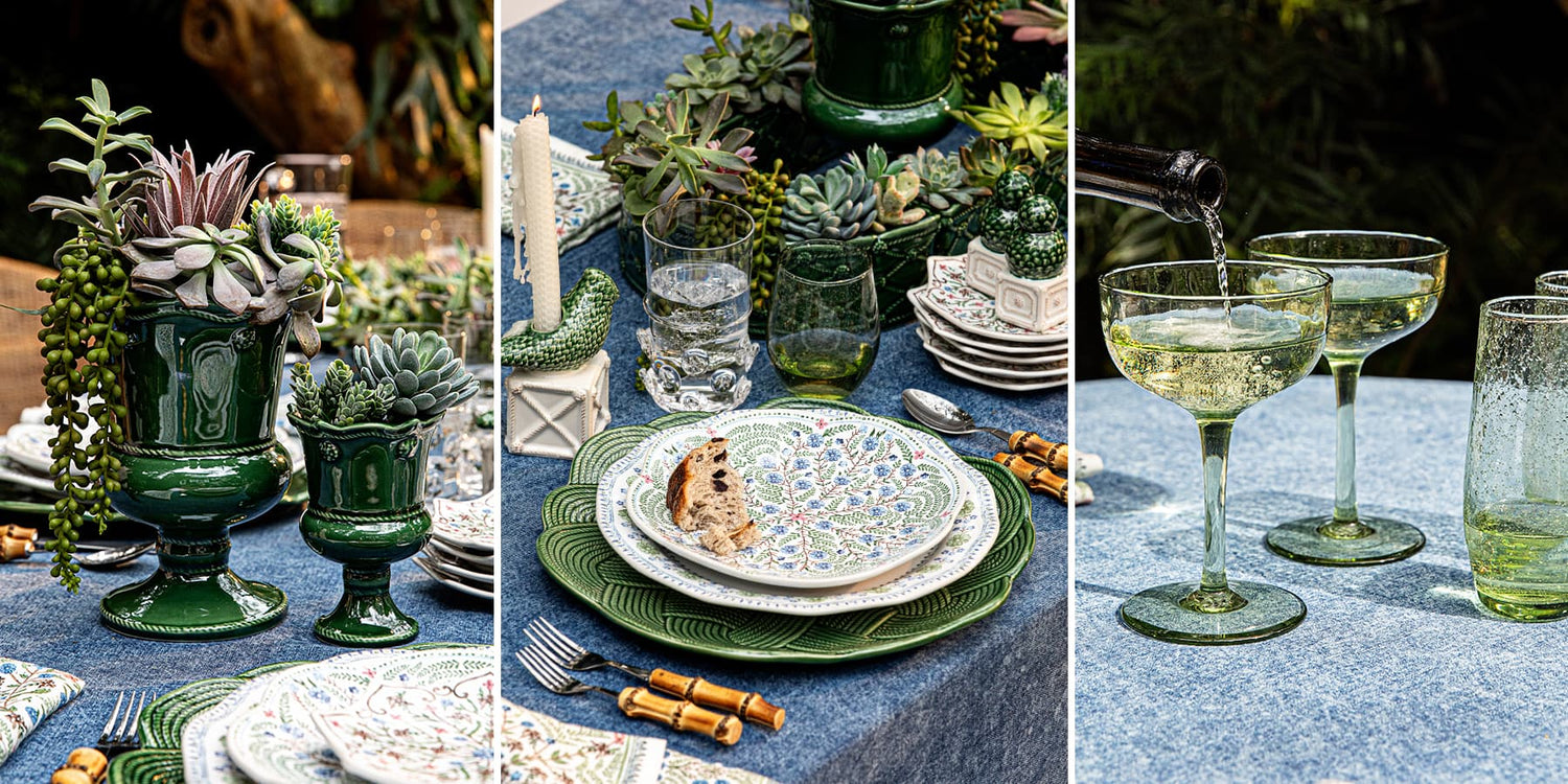 Table setting with green and white dishes, glasses, and decor on a blue tablecloth.